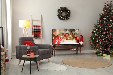 Stylish living room interior with modern TV and Christmas tree