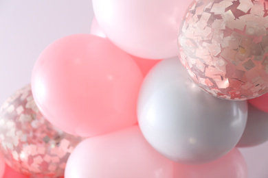Beautiful colorful balloons on light background, closeup
