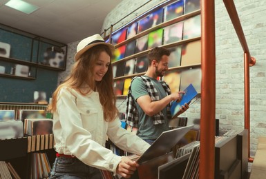 Young people choosing vinyl records in store