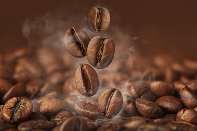 Aromatic roasted coffee beans and steam, closeup