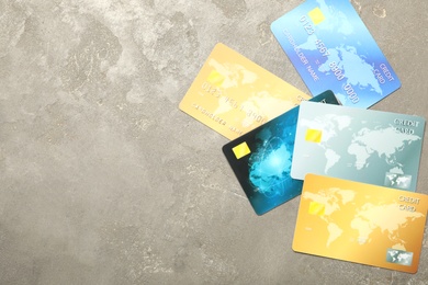 Many different credit cards on grey background, flat lay. Space for text