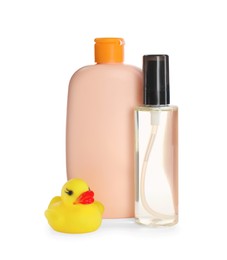 Photo of Bottles of baby oil and rubber duck on white background