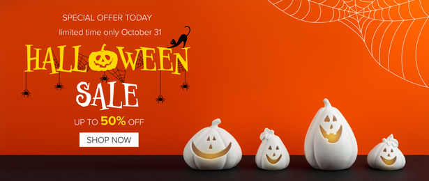Halloween sale banner with white pumpkin shaped candle holders on bright orange background 