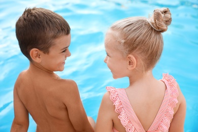 Cute little children at outdoor swimming pool