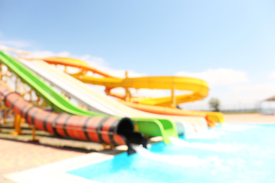 Different colorful slides in water park, blurred view