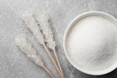 Different types of sugar on light grey table, flat lay