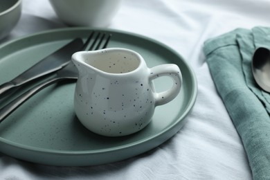 Photo of Stylish empty dishware and cutlery on table, closeup