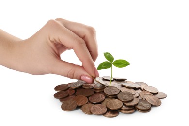 Photo of Woman adding cash to heap of coins with green sprout on white background, closeup