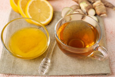 Photo of Tea, honey, lemon and ginger on table, closeup