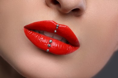 Photo of Young woman with red lips makeup, closeup