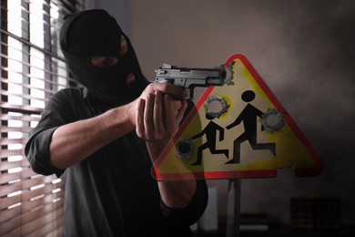 Image of School shooting. Man in mask holding gun in classroom. Warning road sign Children with bullet holes