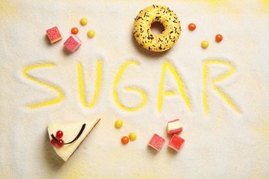 Photo of Flat lay composition with sweets and word SUGAR on yellow background
