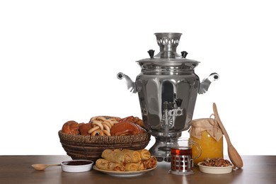 Photo of Traditional Russian samovar with treats on wooden table against white background