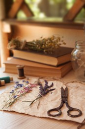 Photo of Composition with beautiful dried flowers and paper on wooden table