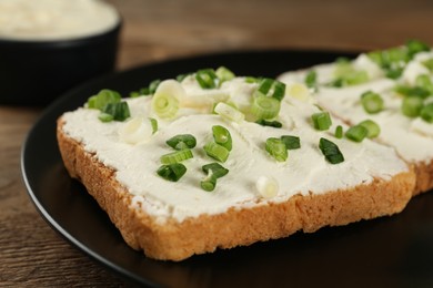 Photo of Delicious sandwiches with cream cheese and chives on table, closeup