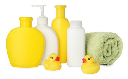 Bottles of baby cosmetic products, towel and rubber ducks on white background