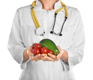 Female doctor with fresh products on white background. Cardiac diet