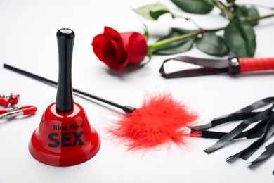 Photo of Bell with text Ring For Sex, leather whip and feather teaser on white background