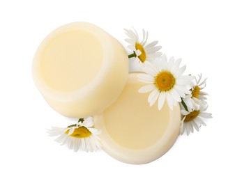Solid shampoo bars and chamomiles on white background, top view. Hair care