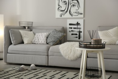 Cozy living room interior with big grey sofa