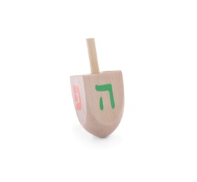 Wooden Hanukkah traditional dreidel with letters Pe and He isolated on white