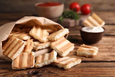 Delicious pita chips on wooden table, closeup