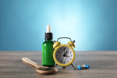 Alarm clock and insomnia remedies on wooden table