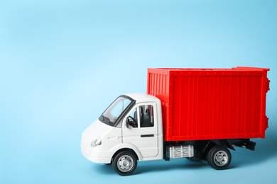 Toy truck on blue background, space for text. Logistics and wholesale concept