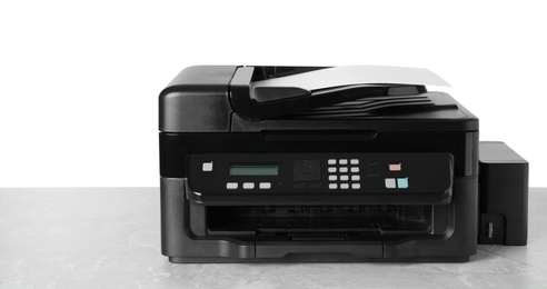 Photo of New modern multifunction printer on light grey table