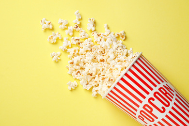 Delicious popcorn on yellow background, top view
