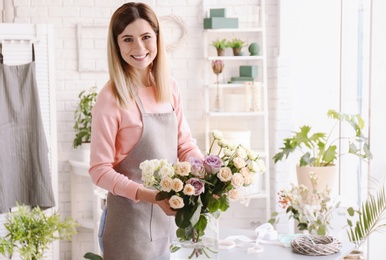 Female florist with roses at workplace