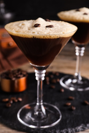 Glass of fresh cocktail with coffee beans, closeup