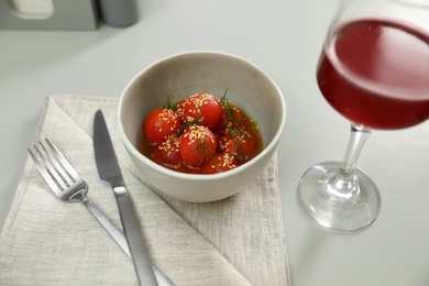 Photo of Tasty soup with blanched tomatoes and beer on light table