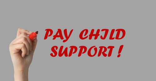 Woman with marker and phrase PAY CHILD SUPPORT! on light grey background, closeup. Banner design