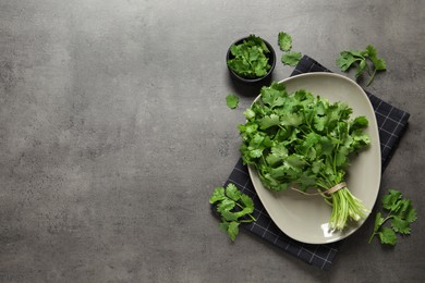 Fresh aromatic cilantro on grey table, flat lay. Space for text