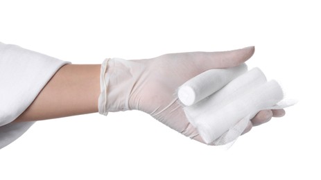 Doctor holding gauze bandage rolls on white background, closeup