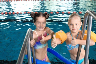 Cute little girls in indoor swimming pool