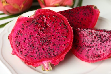 Plate of delicious cut red pitahaya fruit, closeup