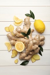 Photo of Fresh lemons and ginger on white wooden table, flat lay