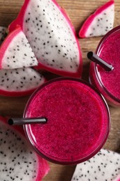 Delicious pitahaya smoothie and fresh fruits on table, flat lay