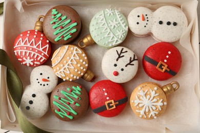 Photo of Beautifully decorated Christmas macarons in box, top view