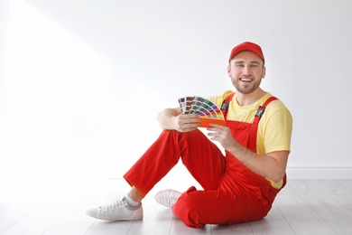 Photo of Male decorator with color palette indoors