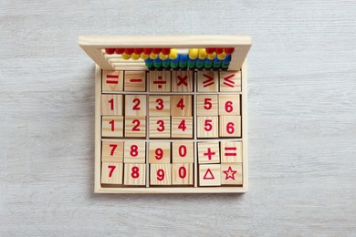 Photo of Math game with numbers and colorful toy abacus on white wooden table, top view