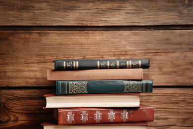 Collection of different books on wooden background