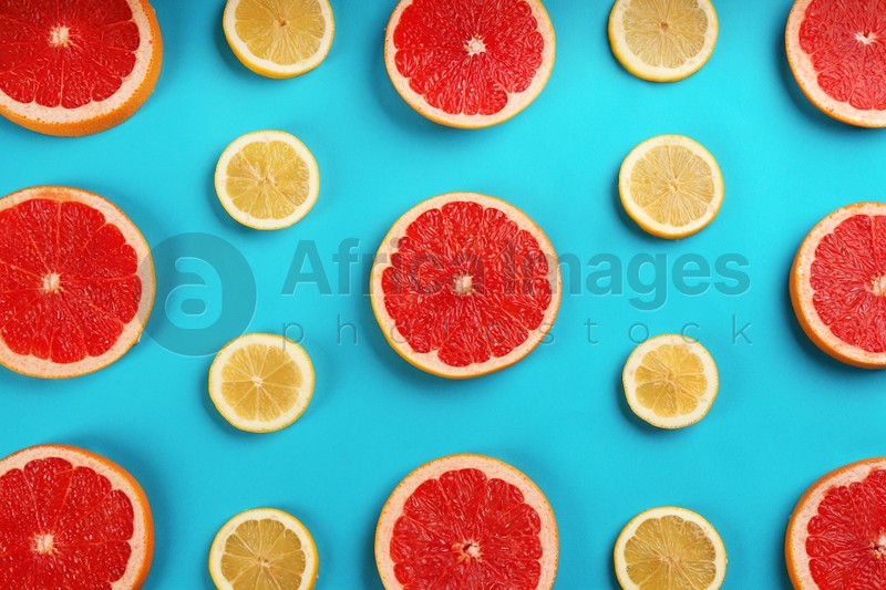 Flat lay composition with tasty ripe grapefruit slices on blue background