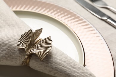 Fabric napkin and decorative ring on plate, closeup