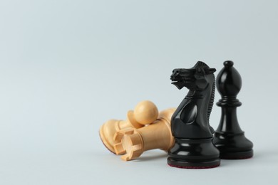 Different chess pieces on light background. Space for text