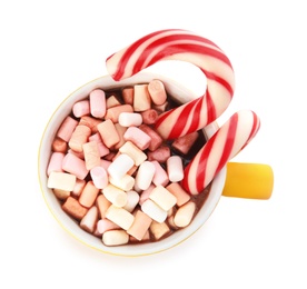 Cup of tasty cocoa with marshmallows and Christmas candy canes isolated on white, top view