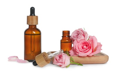 Bottles of essential rose oil and flowers on white background