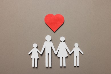 Paper family figures and red heart on light grey background, flat lay. Insurance concept